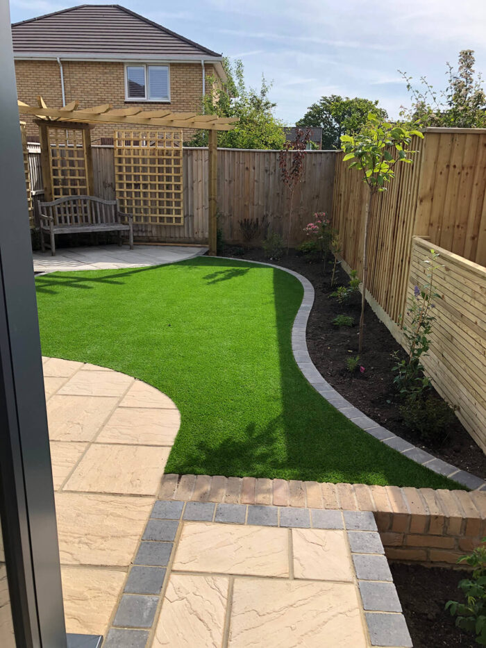 Garden design with artificial grass, fencing and pergola