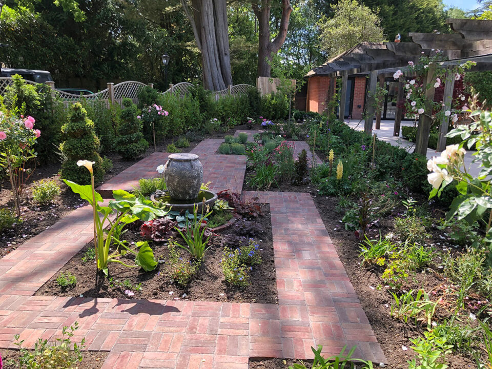 Paved paths around flower beds Holbury.