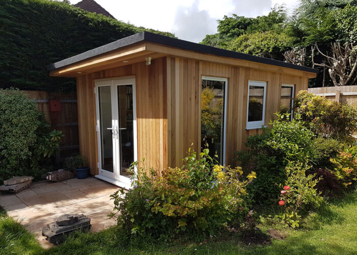 Traditionally built garden room foliage.